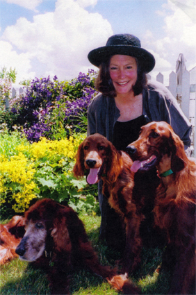 Mary Lynn Broe with her dogs in the garden